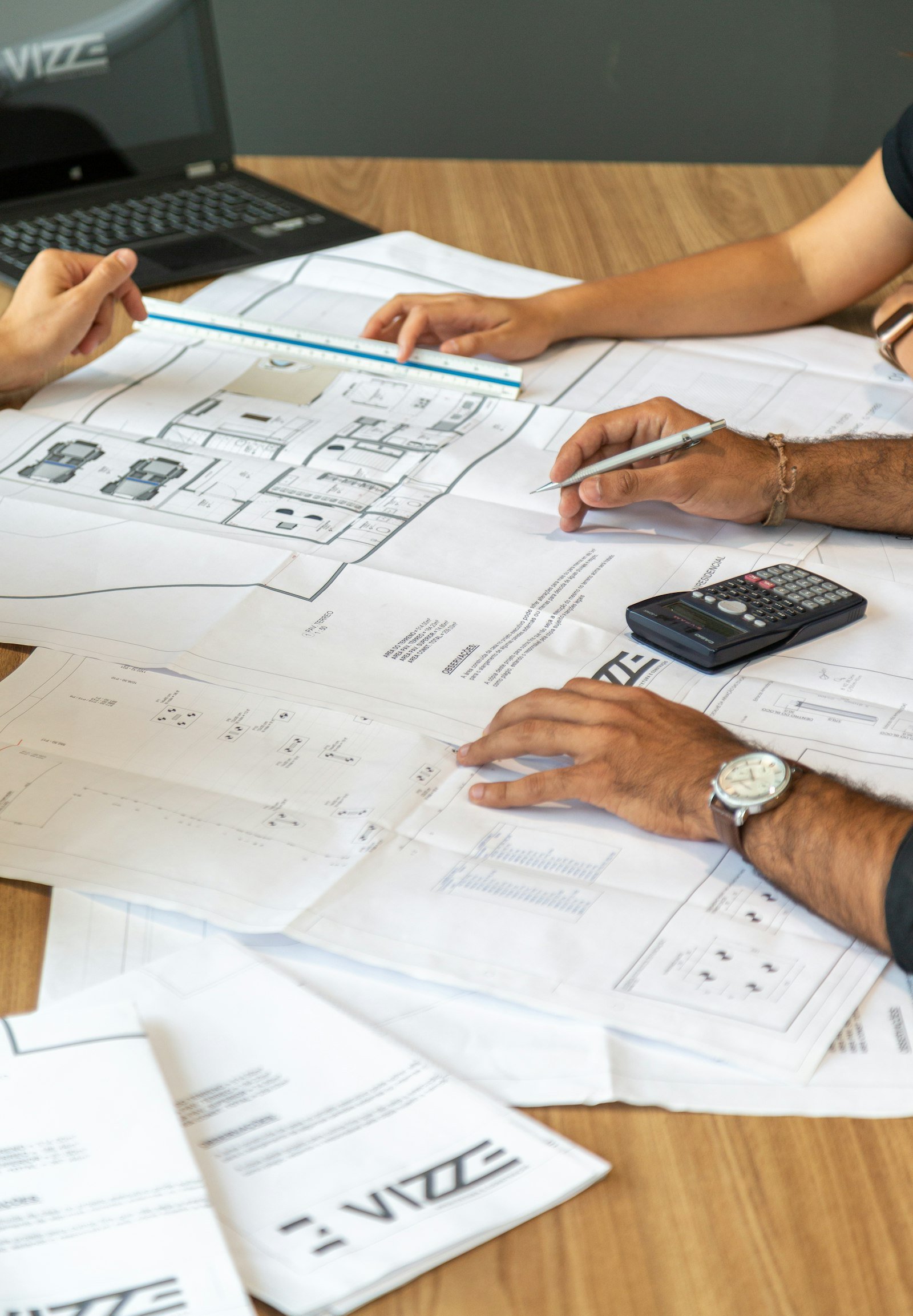 Engineers reviewing architectural blueprints