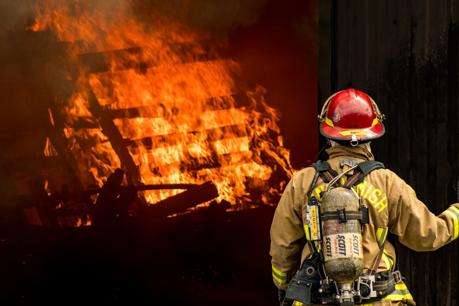 Firefighter facing a building fire