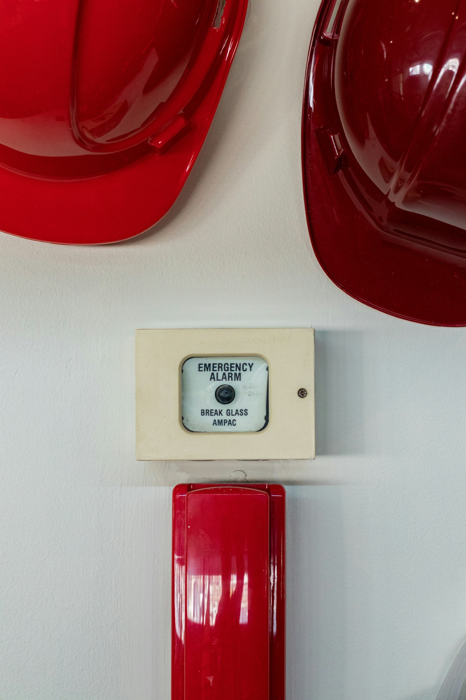Hard hats beside an emergency alarm button